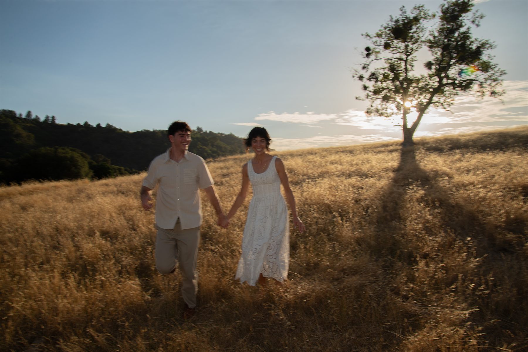 Running hand in hand through a golden field